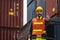 Engineer beard man standing with ware a yellow helmet to control loading and check a quality