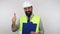 Engineer with beard wearing work helmet, holding flip board and making thumb up sign.