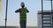 Engineer the builder on the roof of the building stands in vr glasses and moves his hands using the interface of the