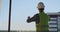 Engineer builder on the roof of the building at sunset stands in VR glasses and moves his hands using the interface of