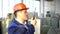 Engineer builder using a walkie talkie giving instructions at a construction site inside. 4 k