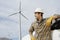 Engineer By Car At Wind Farm