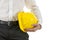 Engineer carrying a yellow hardhat under his arm
