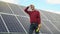 An engineer checks solar panels. Portrait of a successful young engineer on the background of a solar power station