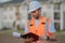 Engineer with clipboard, building inspection. Caucasian man, construction worker in helmet at construction site