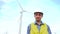 Engineer doing yes gesture by nodding his head in front of wind turbines ecological energy industry power windmill