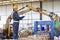 Engineer driving a loader in the recycling plant. Factory recycle workers are using a tablet to control work in the recycling