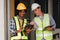 Engineer and Foreman builder team at construction site. American African foreman construction standing at construction
