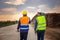 Engineer and foreman worker checking project at building site, Engineer and builders in hardhats discussing on construction site,