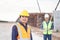 Engineer and foreman worker checking project at building site, Engineer and builders in hardhats in infrastructure construction