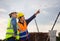 Engineer and foreman worker checking project at building site, Engineer and builders in hardhats in infrastructure construction