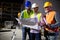 Engineer, foreman and worker discussing in building construction site