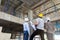 Engineer, foreman and worker discussing in construction site