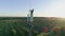 Engineer with gadget connected a mobile communication on radio telecommunication tower on background of blue sky with