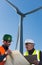 Engineer and geologist consult close to wind turbines in the countryside