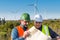 Engineer and geologist consult close to wind turbines in the countryside