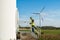 Engineer and geologist consult close to wind turbines in the countryside