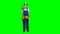 Engineer girl in a helmet and overalls holds a drill in her hands . Green screen