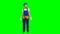 Engineer girl in a helmet and suit looks around . Green screen