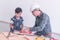 Engineer Handyman Father is teaching his boy to work on construction woodwork tools