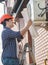 Engineer in hardhat looking in plan of air conditioning system