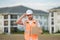 Engineer hold paper board for text. Builder showing signboard placard banner, poster. Builder at construction site