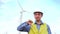 Engineer holding, thumb down in front of wind turbines ecological energy industry power windmill