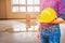 Engineer holding yellow safety helmet plastic and water leak drop interior office background