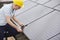 Engineer Installing Solar Panels On Roof Of House