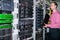 An engineer with an Internet switch is near the racks with computer equipment. The system administrator works in the server room