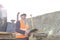 Engineer looking away while holding clipboard at construction site