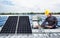 Engineer maintenance solar panel equipment on factory roof