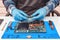 Engineer makes dismantling of RAM for disassembling and repairing a laptop