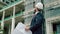 Engineer, male in a white safety helmet developer at a construction site checks on the drawings at what stage the