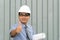 Engineer or manager wearing white hardhat while showing thumbs up.Senior engineer holding some blueprints and showing