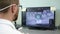 Engineer models implant teeth for customers, bearded guy into 3D glasses sitting in front monitor of computer