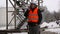 Engineer near to the oil tank in winter