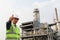 Engineer oil refinery with thumbs up gesture