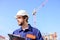 Engineer protective helmet stand in front of blue sky background. Builder engineer helmet works at construction site