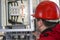 Engineer in red control high voltage fuse in power plant