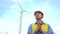 Engineer rubs his hands near wind turbines ecological energy industry power windmill