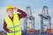 Engineer with safety helmet with industrial port containers background