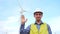 Engineer saluting in front of wind turbines ecological energy industry power windmill