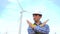 Engineer showing stop gesture hands crossed in front of wind turbines ecological energy industry power windmill