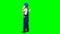 Engineer is standing and talking on the phone with a drawing in her hands. Green screen