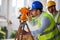 Engineer surveyor working with theodolite at construction site