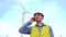 Engineer talking mobile phone on wind turbines ecological energy industry power windmill