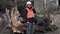 Engineer talking on smartphone near to abandoned, destroyed buildings