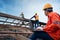 Engineer technician construction worker control roofer working on roof structure of building in construction site, Roof metal