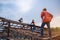 Engineer technician watching team of roofer working on roof structure of building in construction site, Roof metal sheet